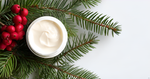 A festive display of SpruceAlive Cream with pinecones, red berries, and spruce branches, emphasizing its nourishing ingredients and natural antioxidant properties.