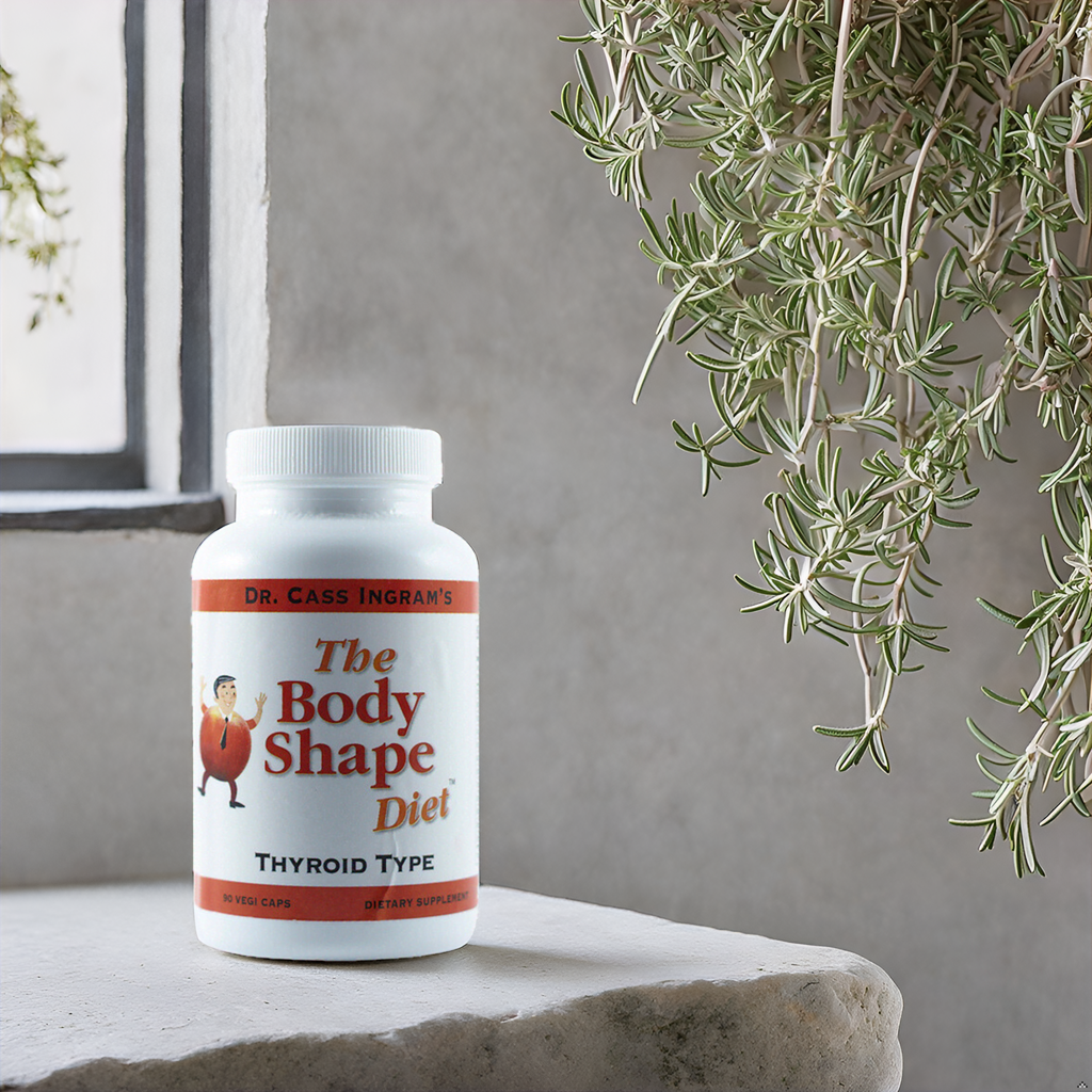 A bottle of The Body Shape Diet Thyroid Support Formula on a stone shelf surrounded by fresh herbs, showcasing its traditional Mediterranean herb blend crafted by Dr. Cass Ingram.