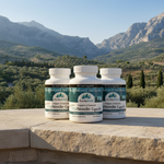Three bottles of Purely Vital supplements on a stone ledge with a mountainous landscape in the background.
