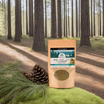 A bag of Wild Pine Needle Tea displayed in a lush forest setting, surrounded by pine cones, symbolizing its wild-harvested ingredients and pristine origins as inspired by Dr. Cass Ingram.