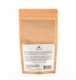 A back view of the Wild Pine Needle Tea bag, showcasing detailed ingredient and preparation instructions, emphasizing its natural origins and Dr. Cass Ingram’s expertise.
